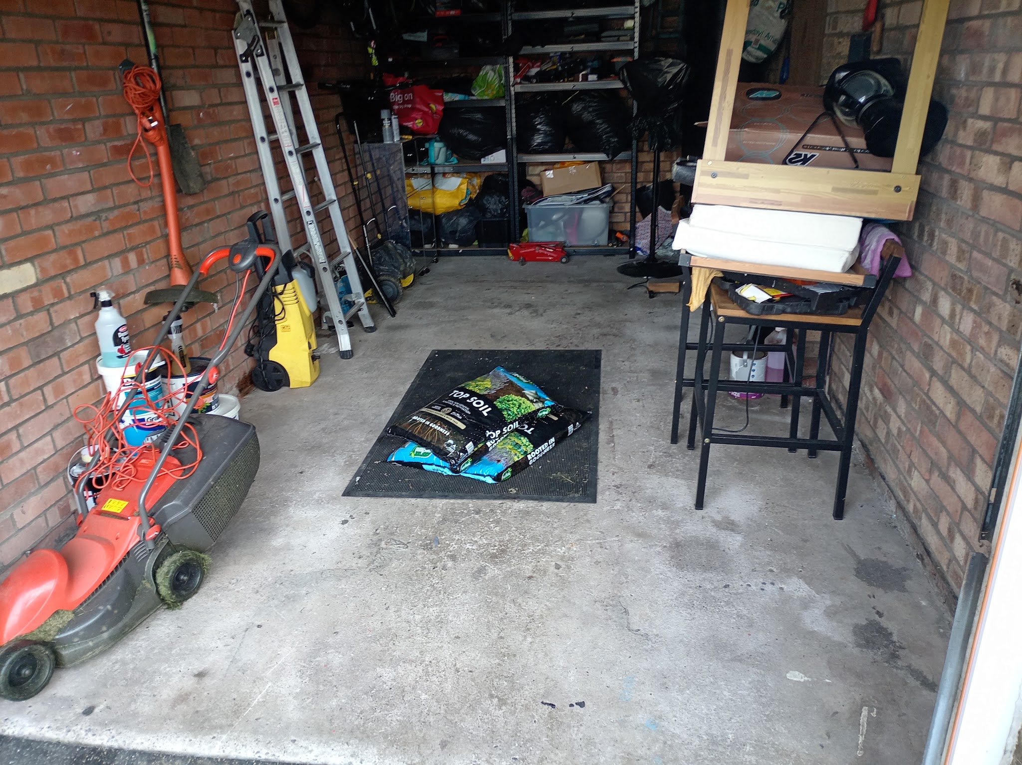 A garage with a clear concrete floor after a clear-out